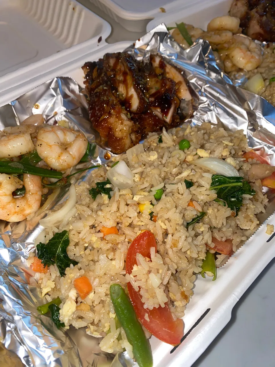 Chicken fried rice with garlic chicken and prawns in a foil tray